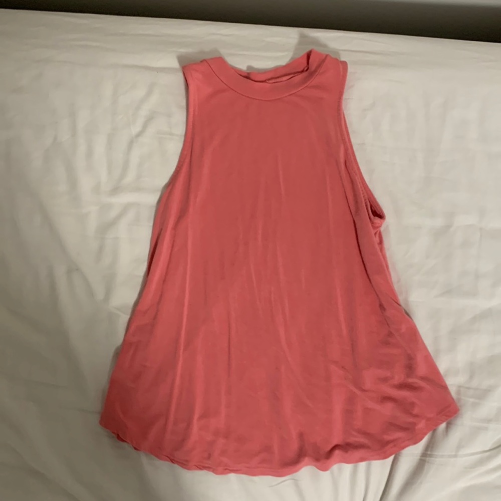 Loose and flowy pink shirt.